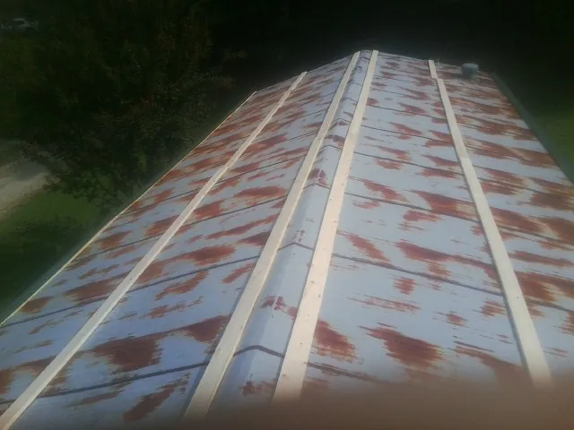 Rusted metal roof panels with new wood purlins before replacement — Storm Damage Roof Repair in Choctaw by Roofing Brothers